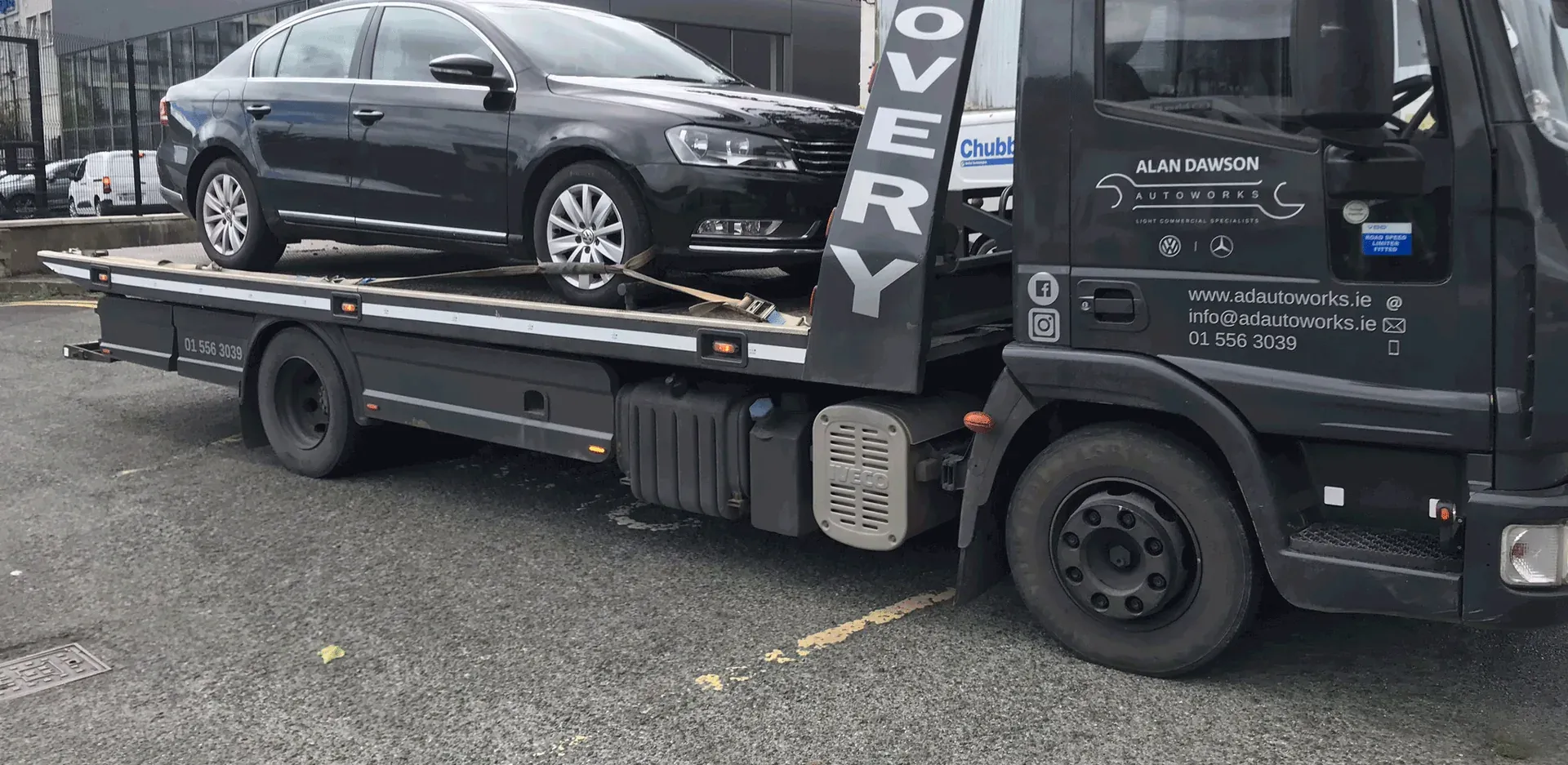 Alan Dawson Autoworks recovery truck with a Volkswagen Passat loaded on its flatbed
