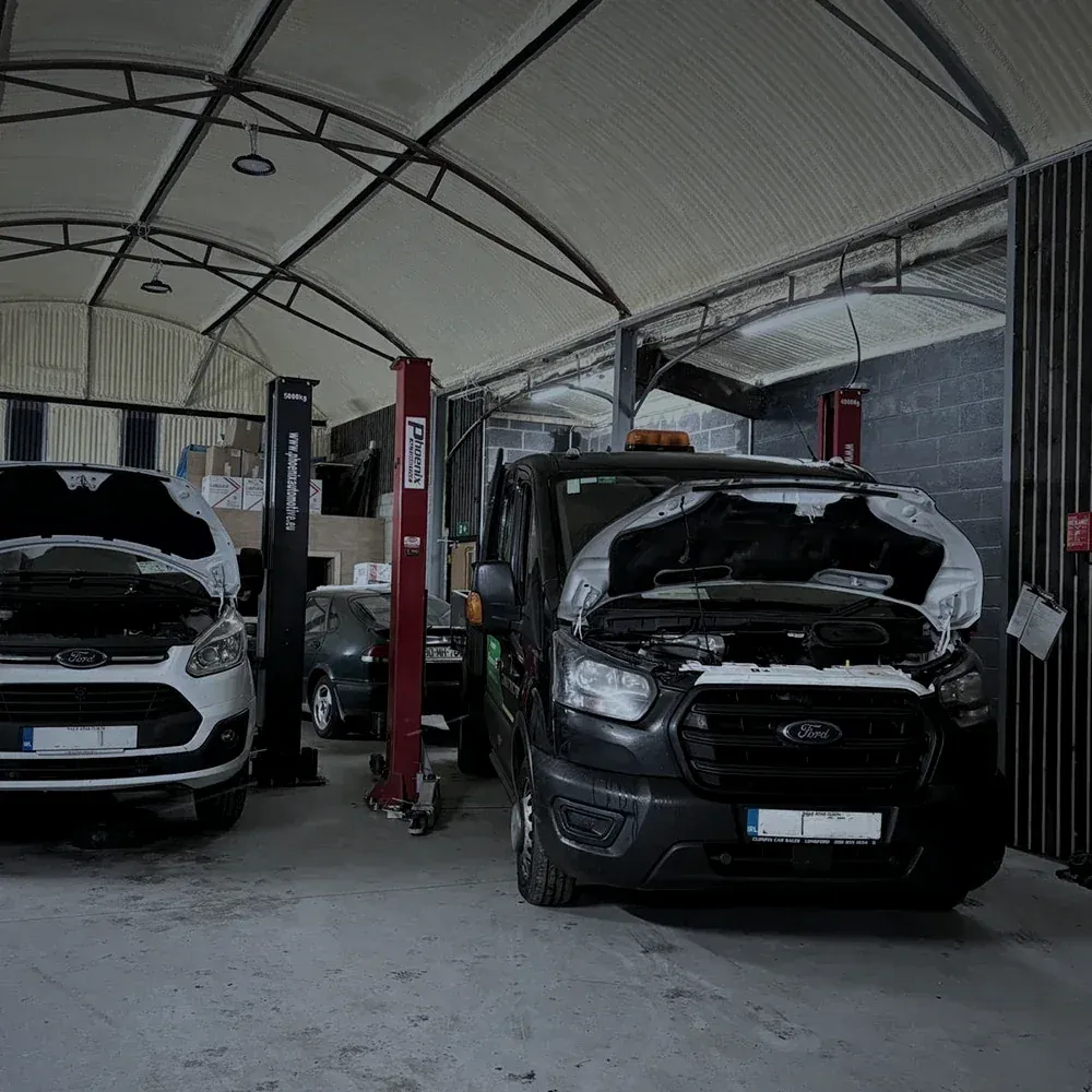 Fleet vans lined up in the Alan Dawson Autoworks workshop for scheduled servicing
