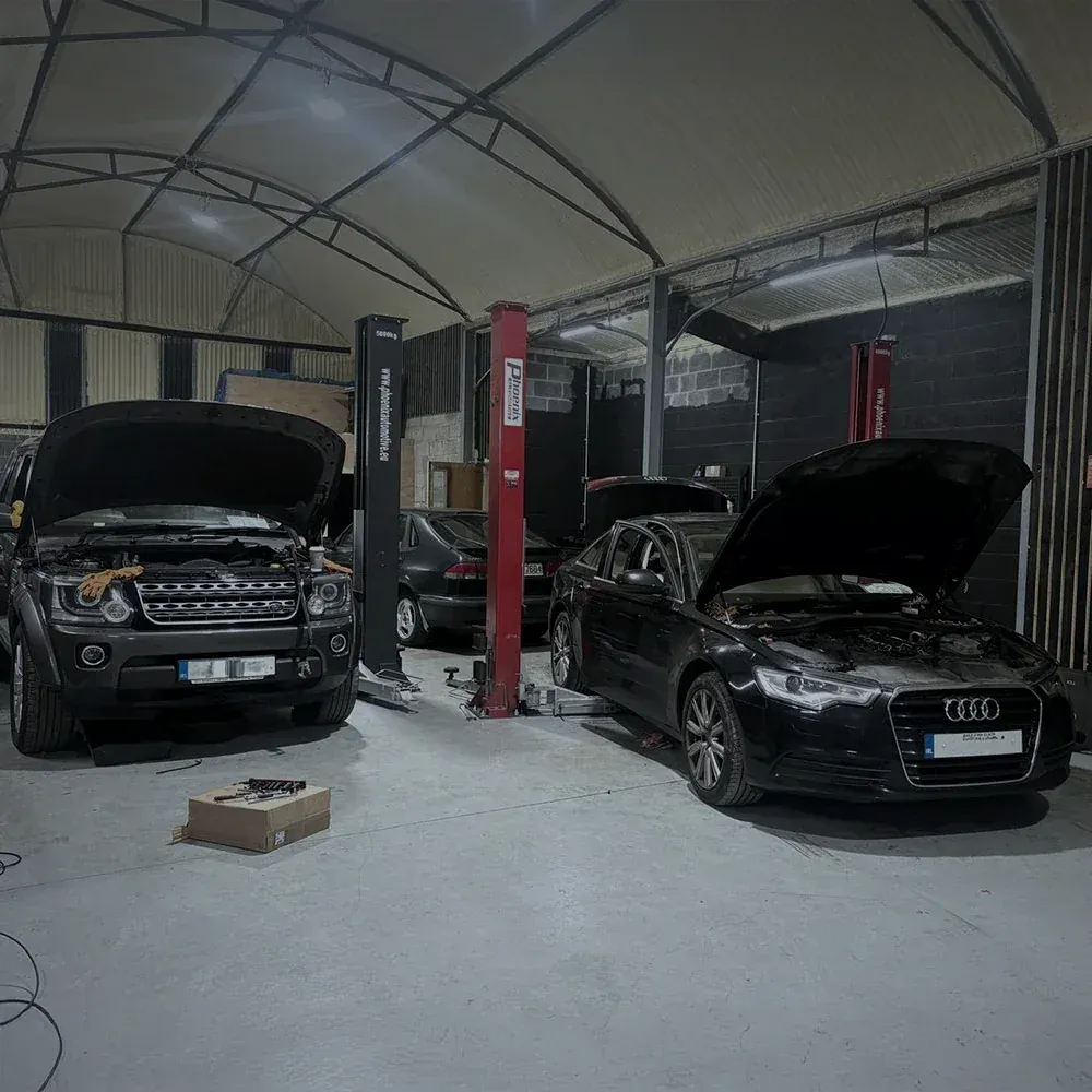 Car up on a two-post lift during a service at the Alan Dawson Autoworks workshop in Navan